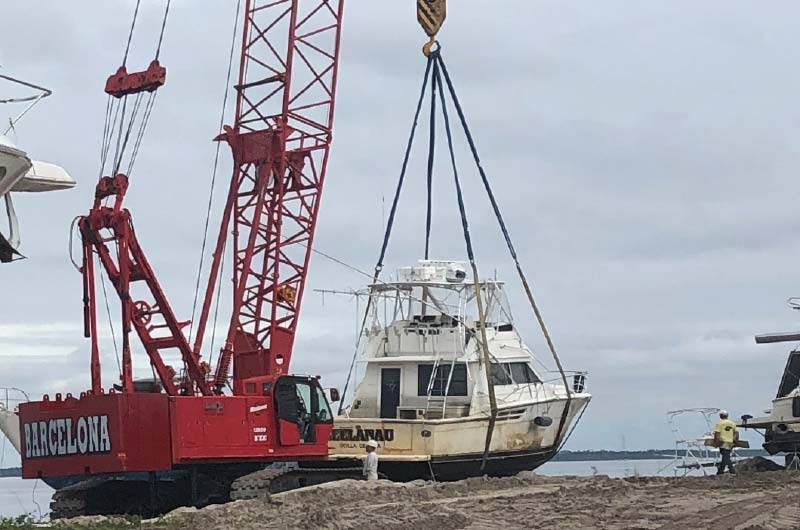 crane lifting sunk boat
