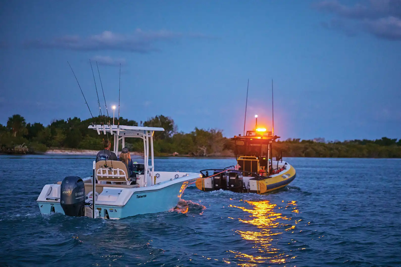 Sea Tow boat towing services including helping a member at dark.